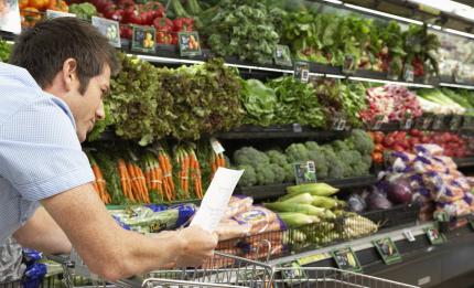 man with shopping list in grocery shop