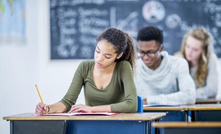 Woman student writing at a desk